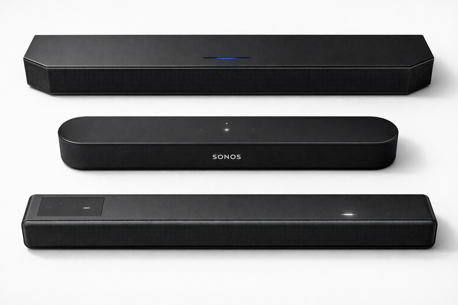 Landscape format (1536x1024) close-up side-by-side product shot of three premium soundbars on a white studio surface: a wide Samsung flagship bar, a compact Sonos Beam, and a Sony HT-A5000, each with subtle glow from their LED indicators. Overhead angle, soft studio lighting, crisp product detail, minimalist white background with light gray shadows, professional consumer electronics photography, emphasis on physical design differences and speaker grille textures. 