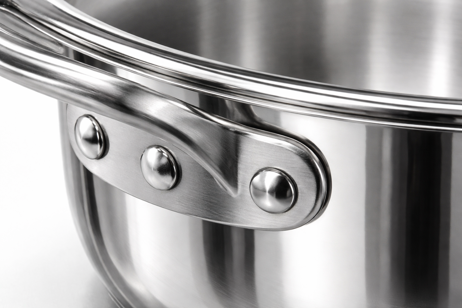 All-Clad Specialty Stainless Steel Tea Kettle detailed view of stainless steel riveted handle and polished surface finish