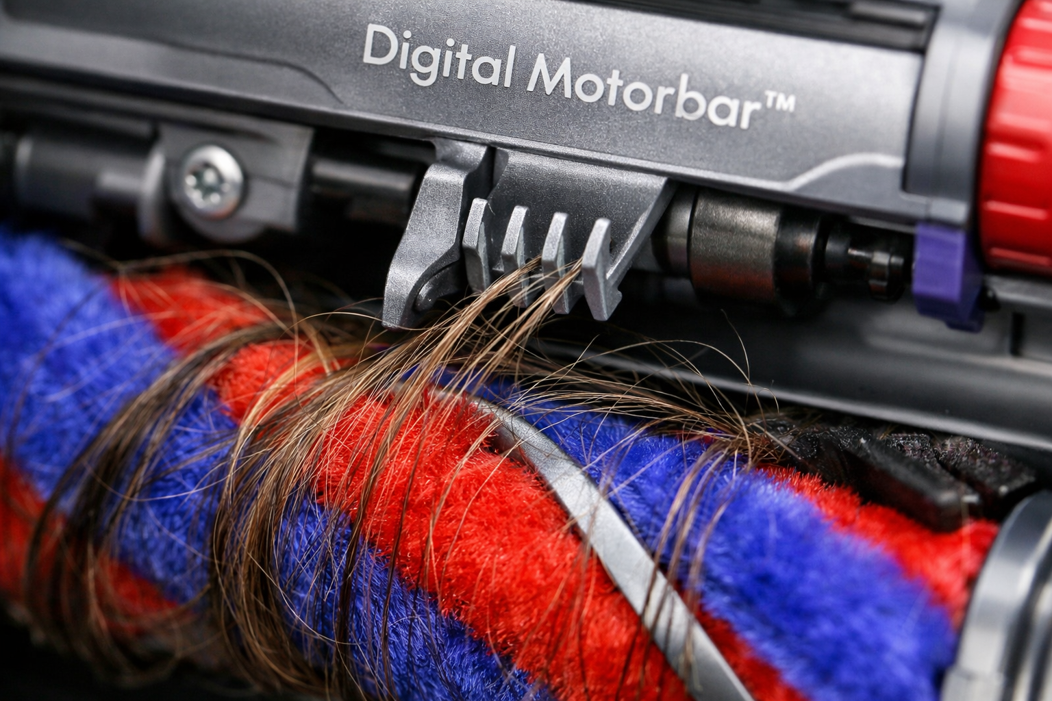Dyson Cleaner Head close-up of Digital Motorbar de-tangling vanes clearing wrapped hair from brush bar