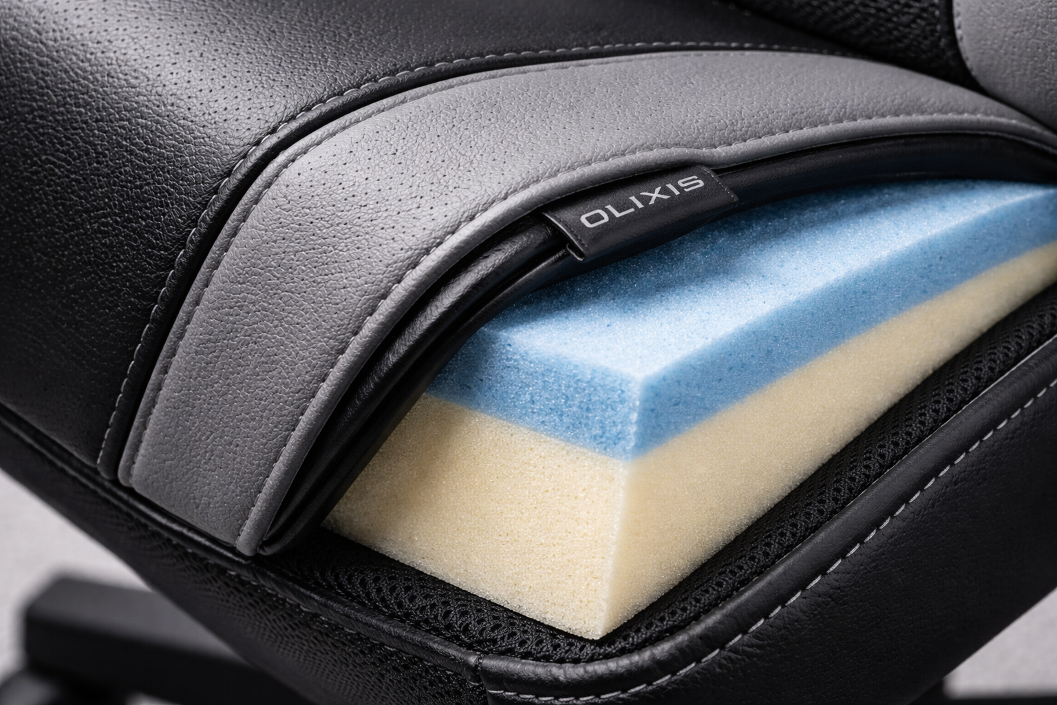 close-up detail shot of OLIXIS chair high-density foam cushioning and PU leather upholstery