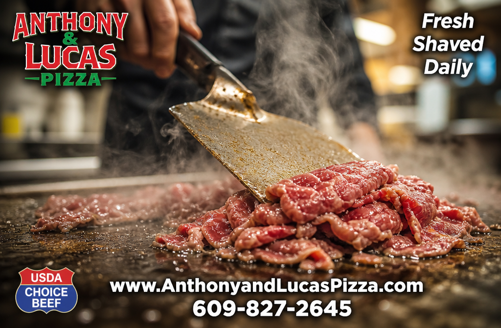 () dramatic close-up action shot of thinly shaved raw USDA Choice ribeye steak hitting a hot flat-top griddle with visible