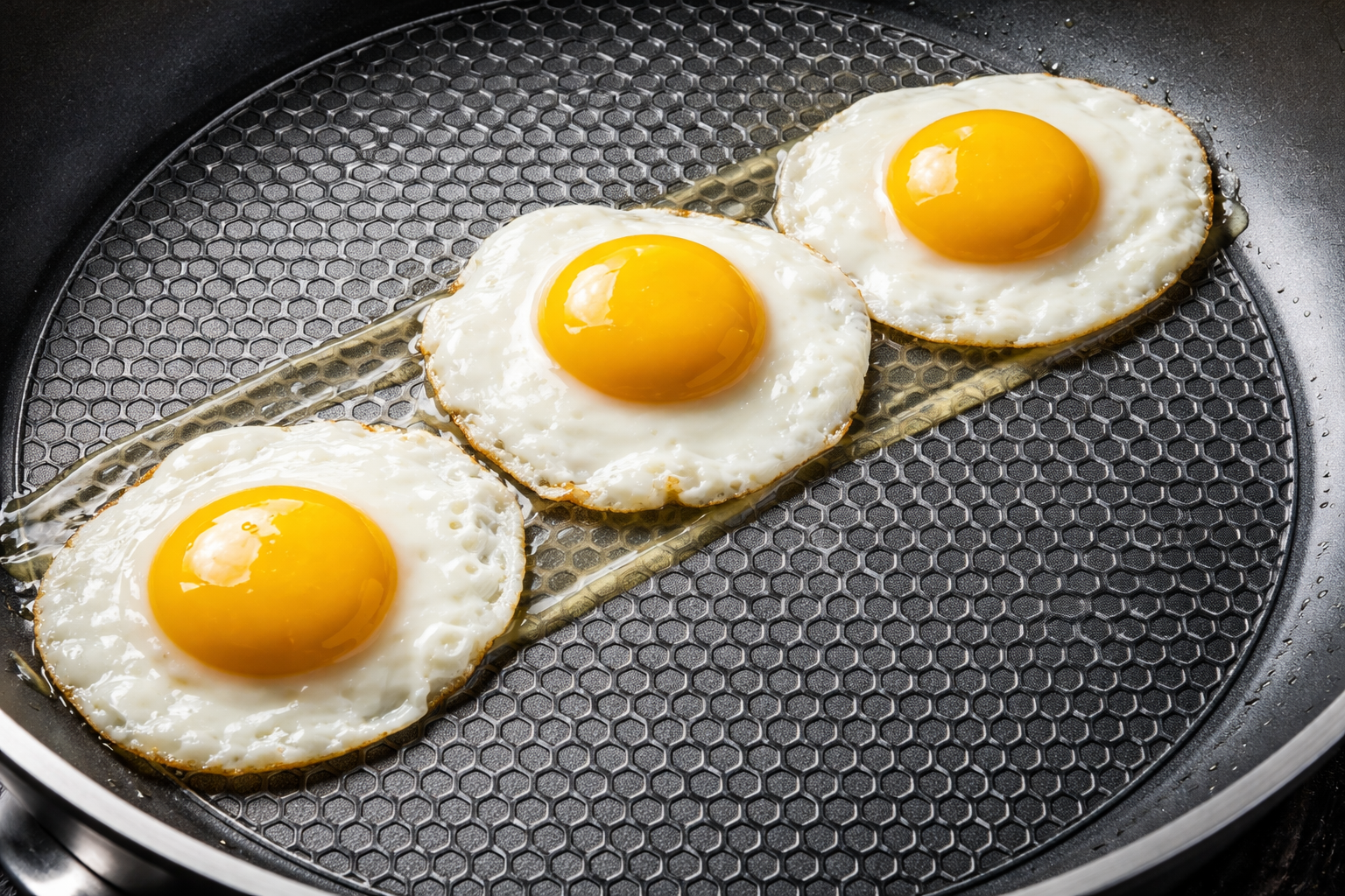 overhead shot of eggs sliding effortlessly across the hybrid nonstick surface